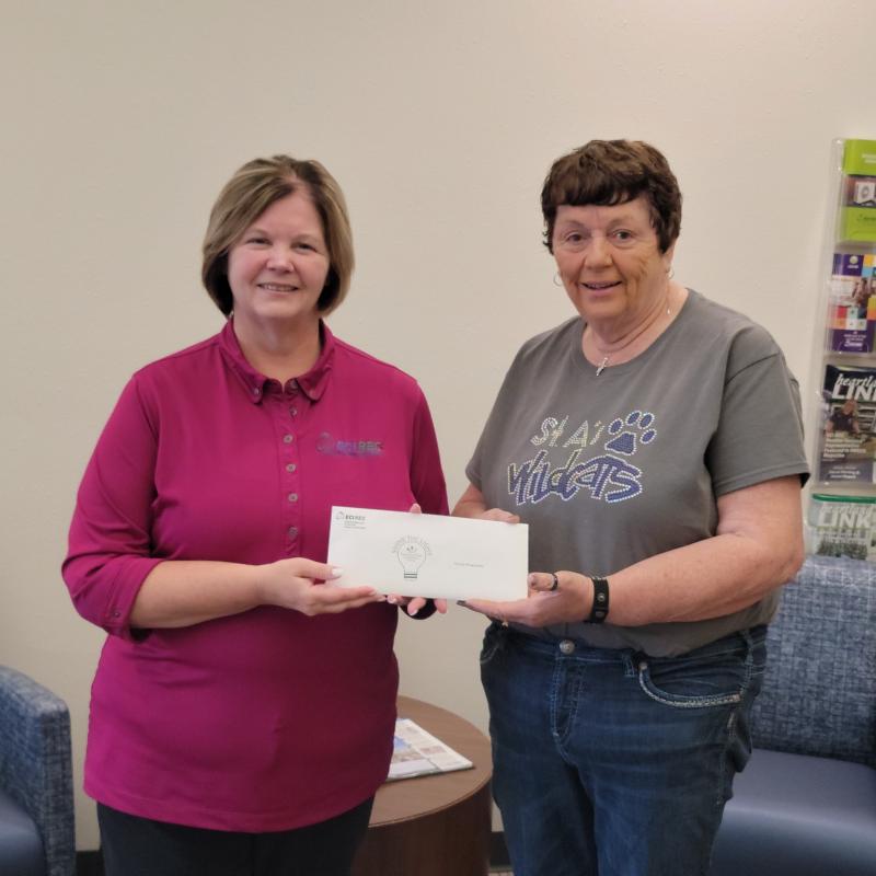 Donna Dellagardelle receiving check from Jennifer Schmitz